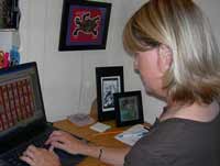 AFTER: External keyboard and mouse on lower surface for optimal arm and hand positioning. Laptop monitor on elevated surface for neutral neck positioning.